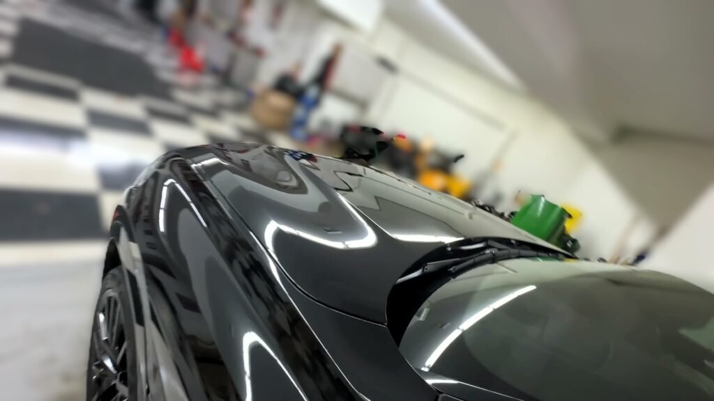 ceramic coating on a black bmw showing very glossy paint
