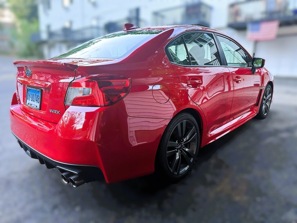 ceramic coating after exterior detail in ct of a red subaru wrx