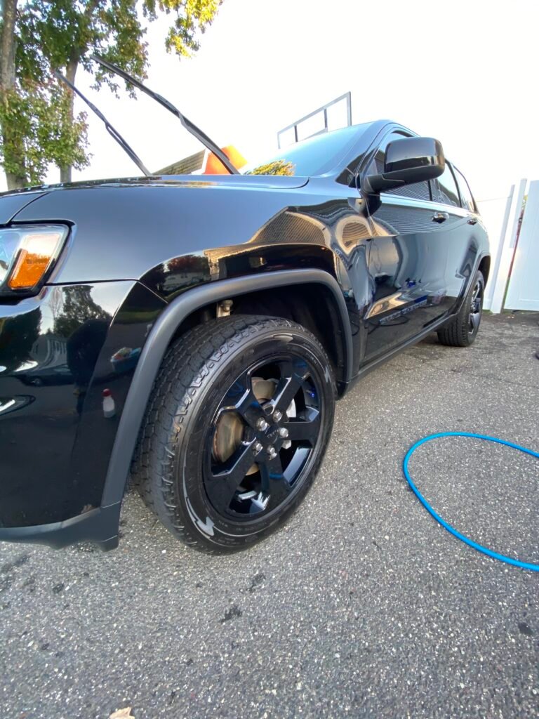 exterior detail of a black jeep showing glossy paint
